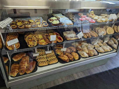Glass display of assorted baked goods in a bakery in West Galt, Cambridge, Ontario