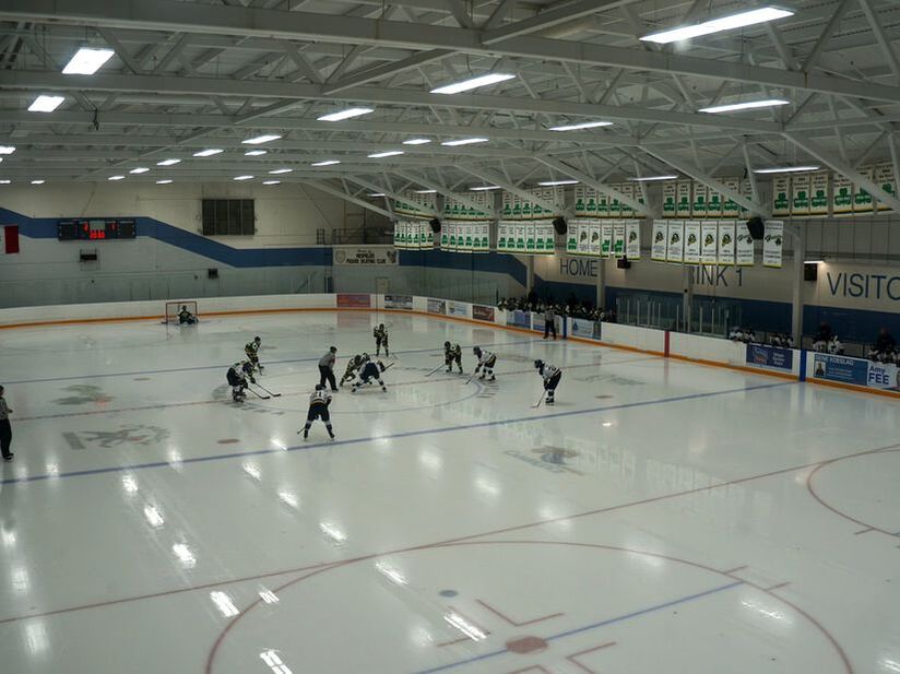 Indoor skating rink with people playing hockey in Hespeler Village, Cambridge, Ontario