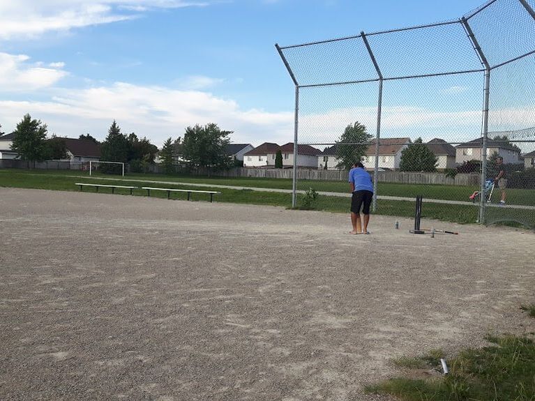 Large baseball diamond with a person up to bad in East Hespeler, Cambridge, Ontario