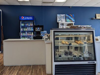 Interior of an eatery with a glass display of food, a Pepsi vending machine in the back in Southwood, Cambridge, Ontario