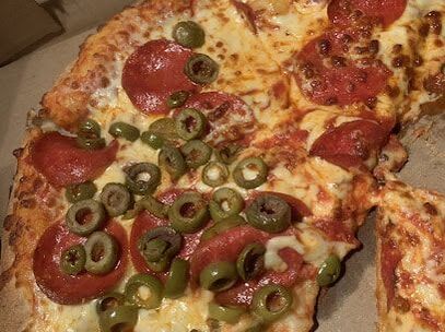 Close up photo of a pepperoni and olive pizza in Silver Heights, Cambridge, Ontario